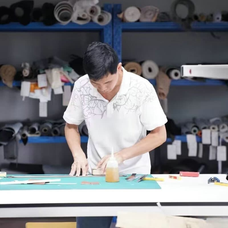 Leather-goods craft work at a production bench